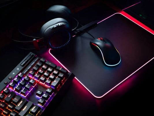A high-performance gaming keyboard and mouse combo on a sleek RGB-lit desk setup, featuring a mechanical keyboard with customizable backlighting and an ergonomic gaming mouse designed for precision and speed.